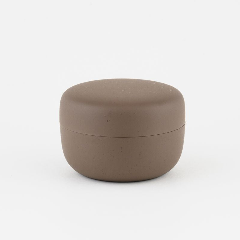 Brown ceramic tea container on a white background