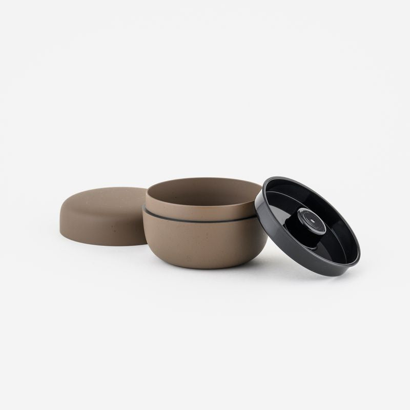 Ceramic tea container with lid on a white background