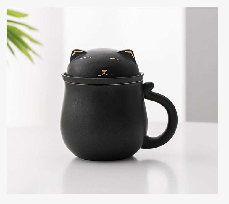 Black cat-shaped mug with a lid on a white surface