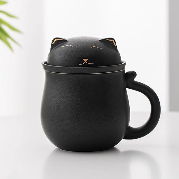 Black cat-shaped mug with a lid on a white surface