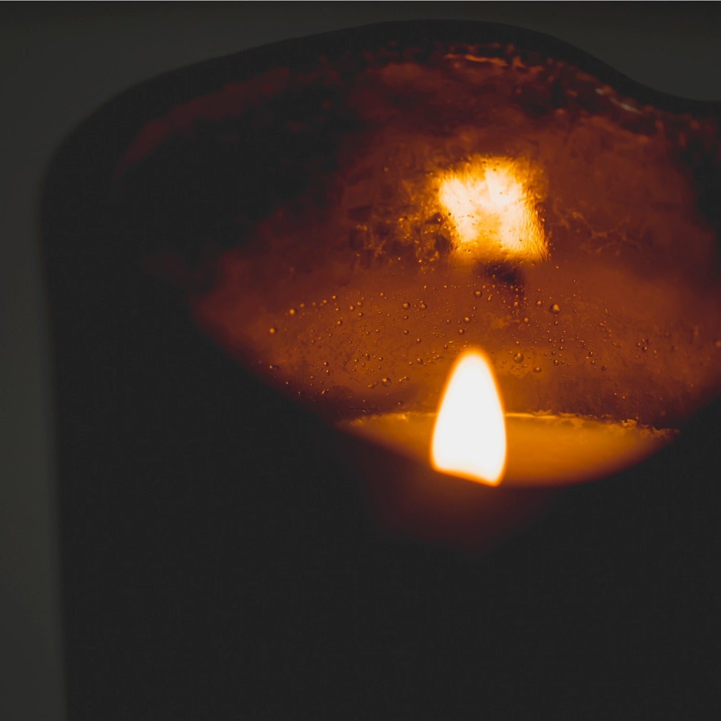 Close-up of a candle with a dark background