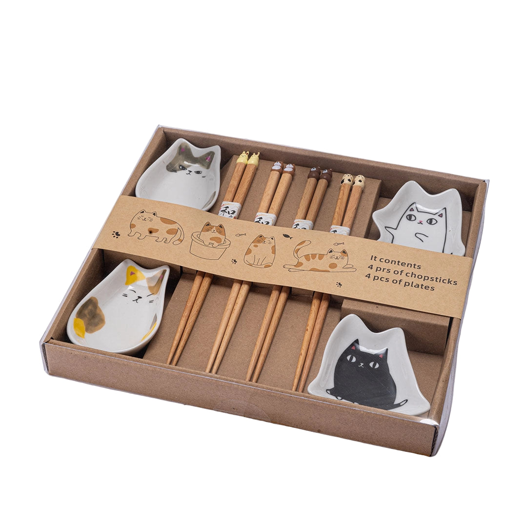 Set of chopsticks and cat-shaped ceramic plates in a box on a white background