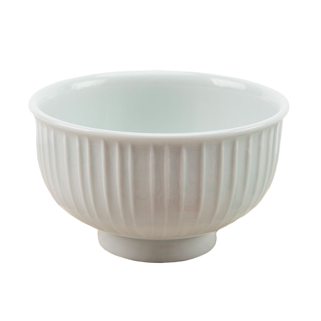 White ceramic bowl with ribbed texture on a white background