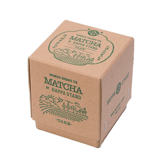 Paper box with green matcha tea branding on a white background