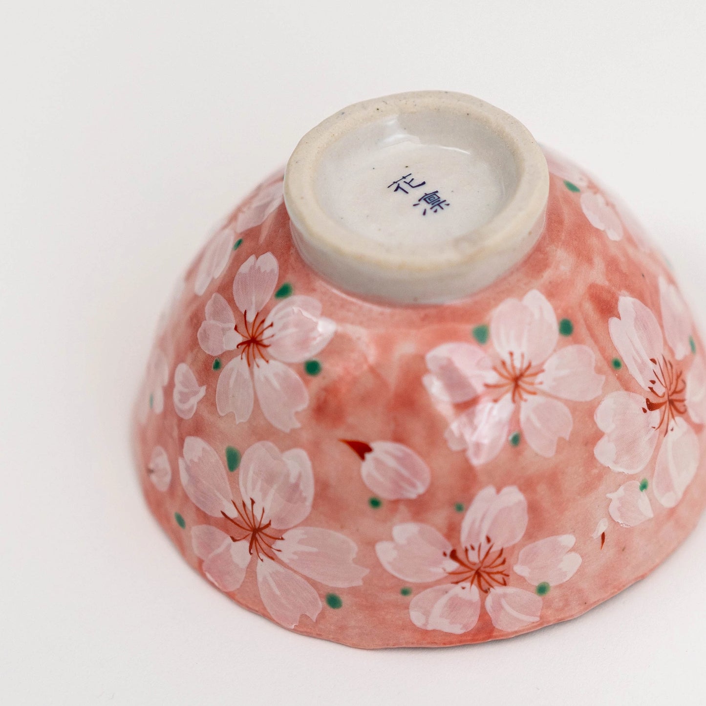 Ceramic bowl with cherry blossom design on a white background