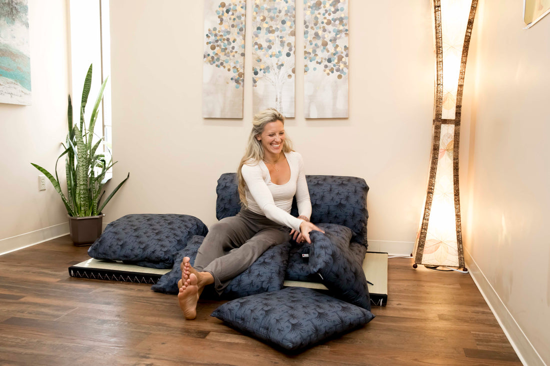 Woman sitting on a tatami mat and shikifuton floor mattress.