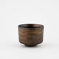 Bronze-colored ceramic cup on a white background