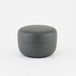 Gray round tea container with lid on a white background
