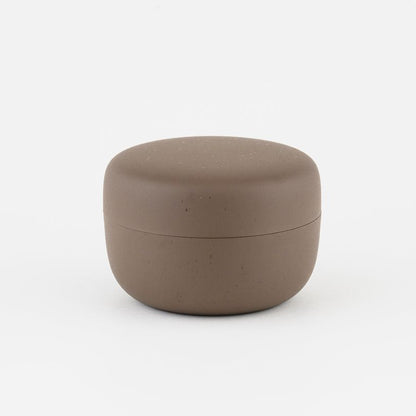 Brown ceramic tea container on a white background
