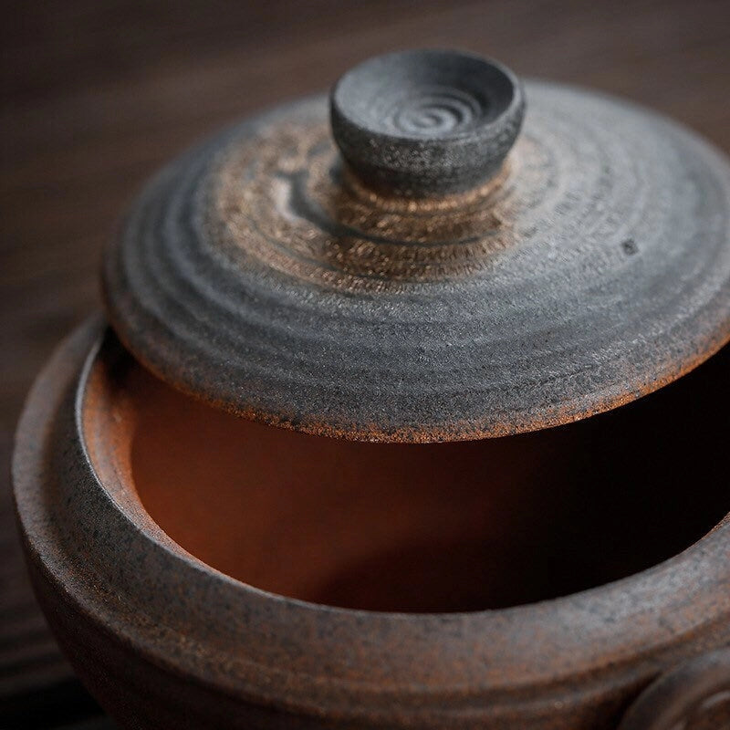 Close-up of a ceramic teapot with a lid on a wooden surface
