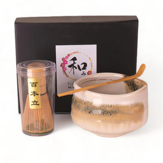 Tea-making set with a whisk, bowl, and box on a white background