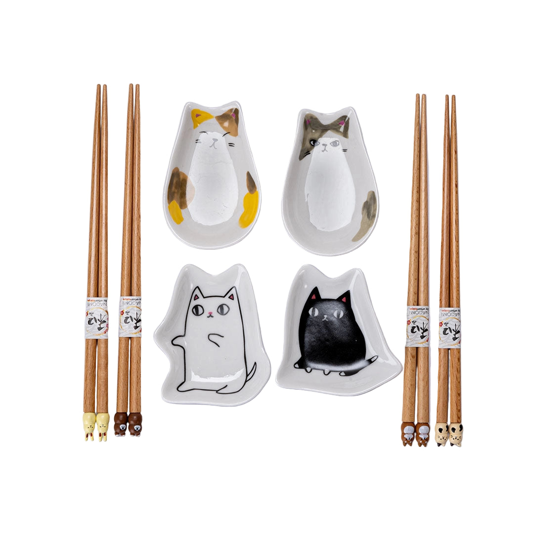Set of chopsticks and cat-shaped ceramic dishes on a light gray background