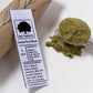 Green tea mask packaging with a spoonful of green powder on a white background