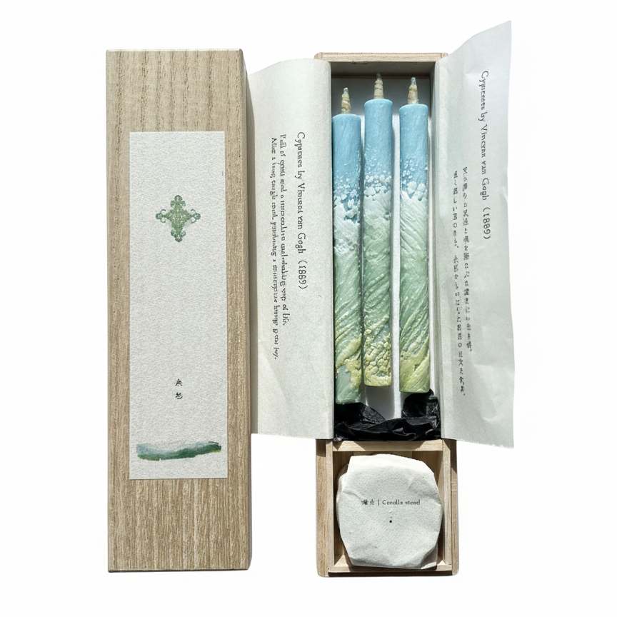 Set of three candles in a decorative box with a white background