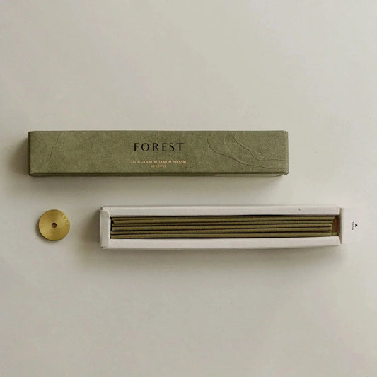 Green packaging box labeled 'FOREST' with a white device on a beige background