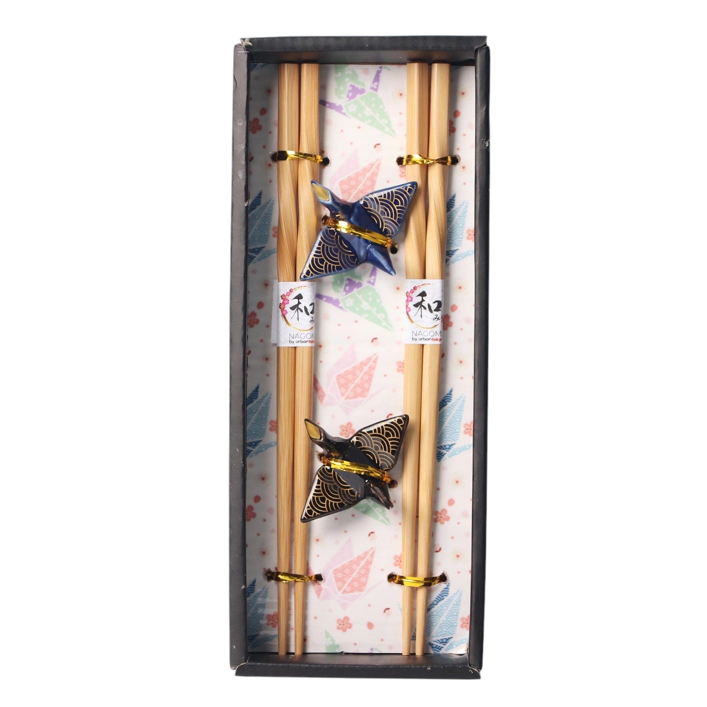 Set of chopsticks with decorative ends in a box with a decorative pattern.