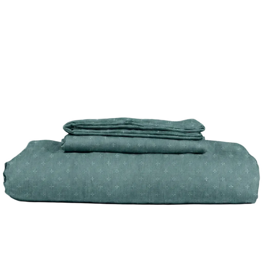 Green textured bed sheet set on a white background