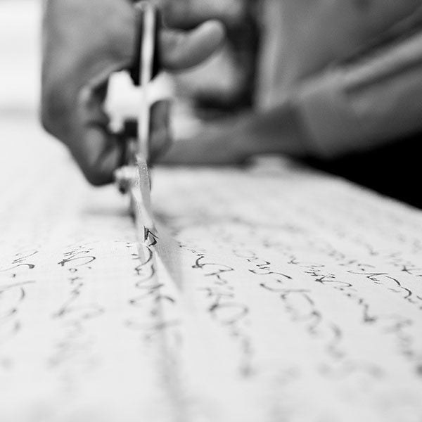 Hands cutting Japanese fabric with scissors in the J-Life workroom