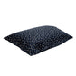 Navy blue pillow with small dragonfly patterns on a white background