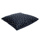 Navy blue floor pillow with dragonfly patterns on a white background