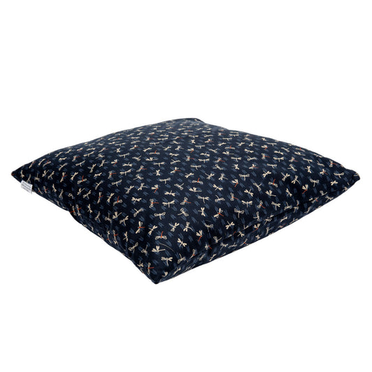 Navy blue floor pillow with dragonfly patterns on a white background