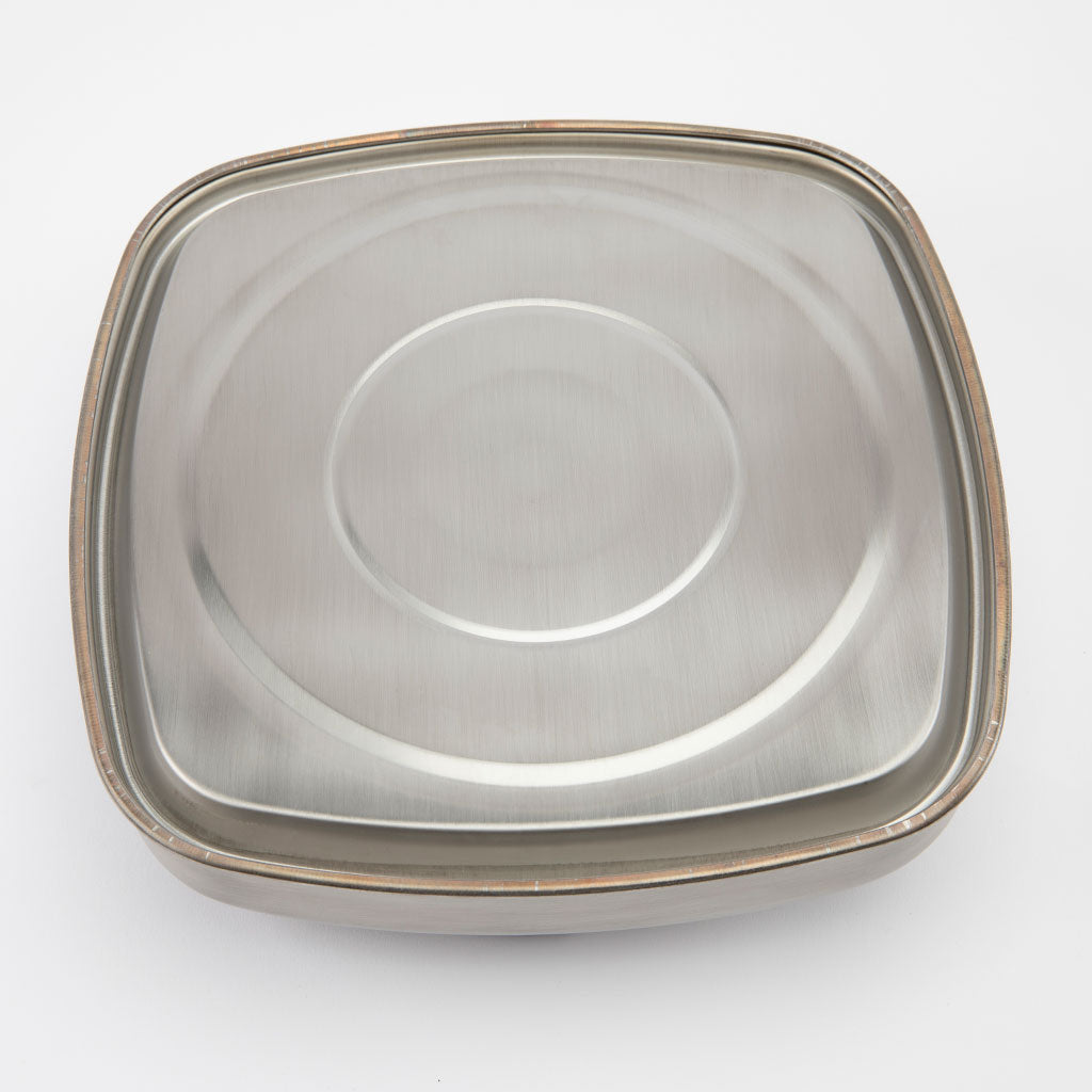 Square stainless steel metallic teapot bottom on a white background