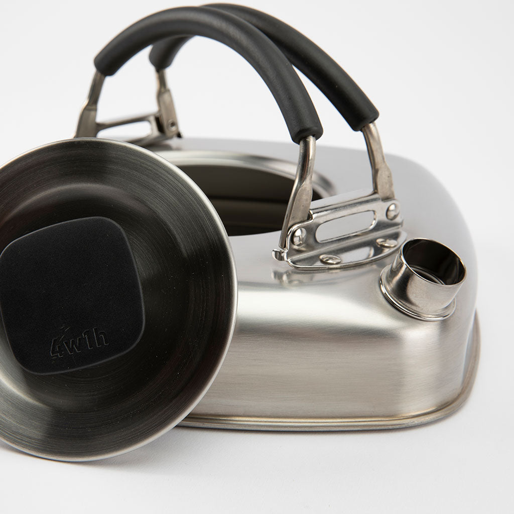 Stainless steel kettle with black handle on a white background