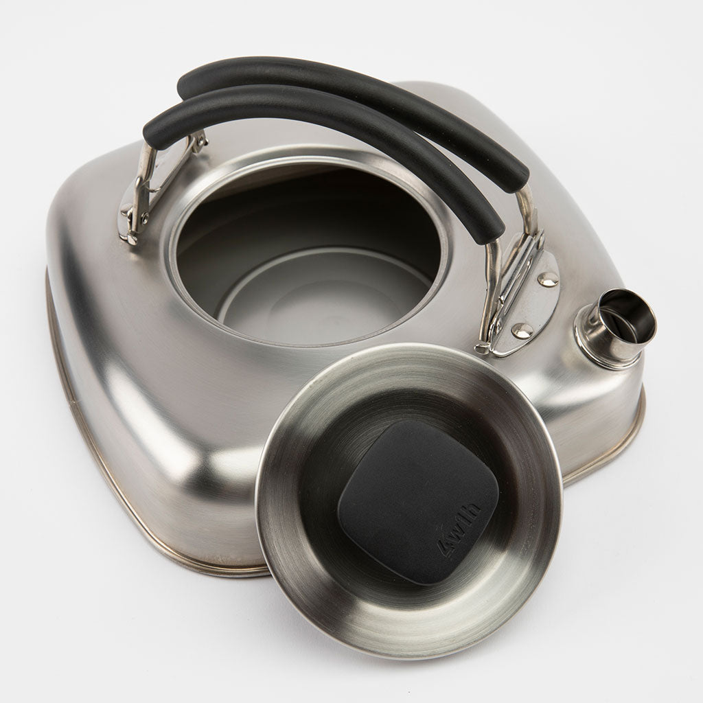 Stainless steel teapot with black rubber handle on a white background