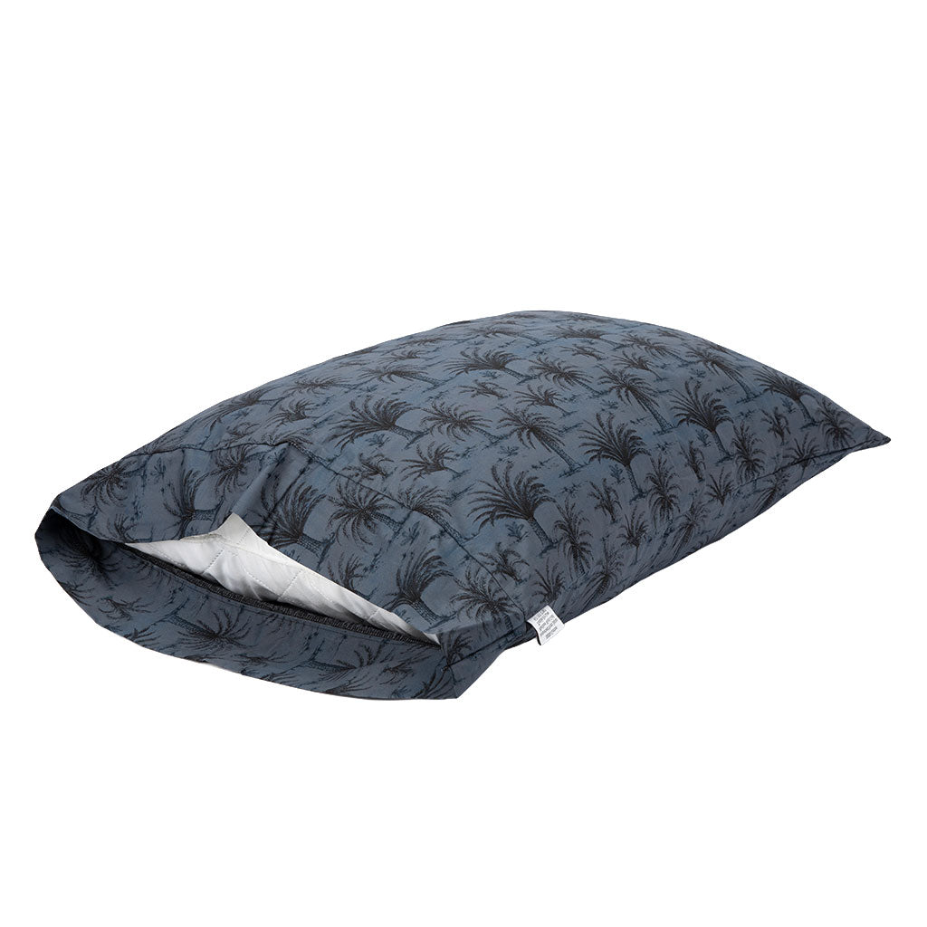 A dark slate blue quilted pillow sham featuring an all-over palm tree pattern, shown with its zipper open to reveal a white interior lining.