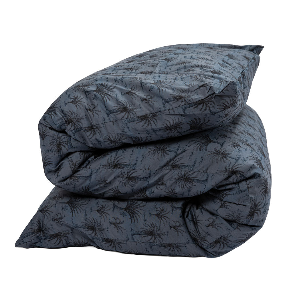 A folded shikifuton with a black palm tree pattern, isolated on a white background.