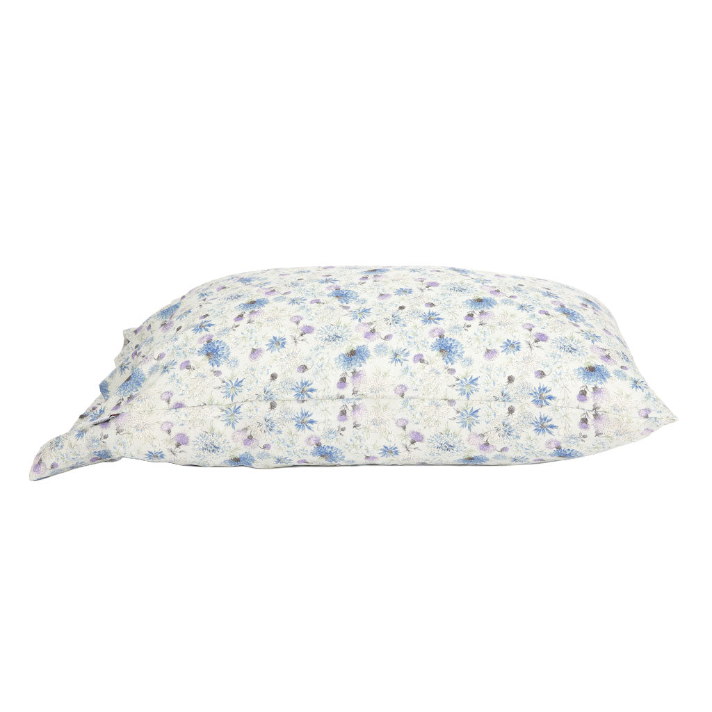 Side angle of a pillowcase with soft purple and blue floral designs.