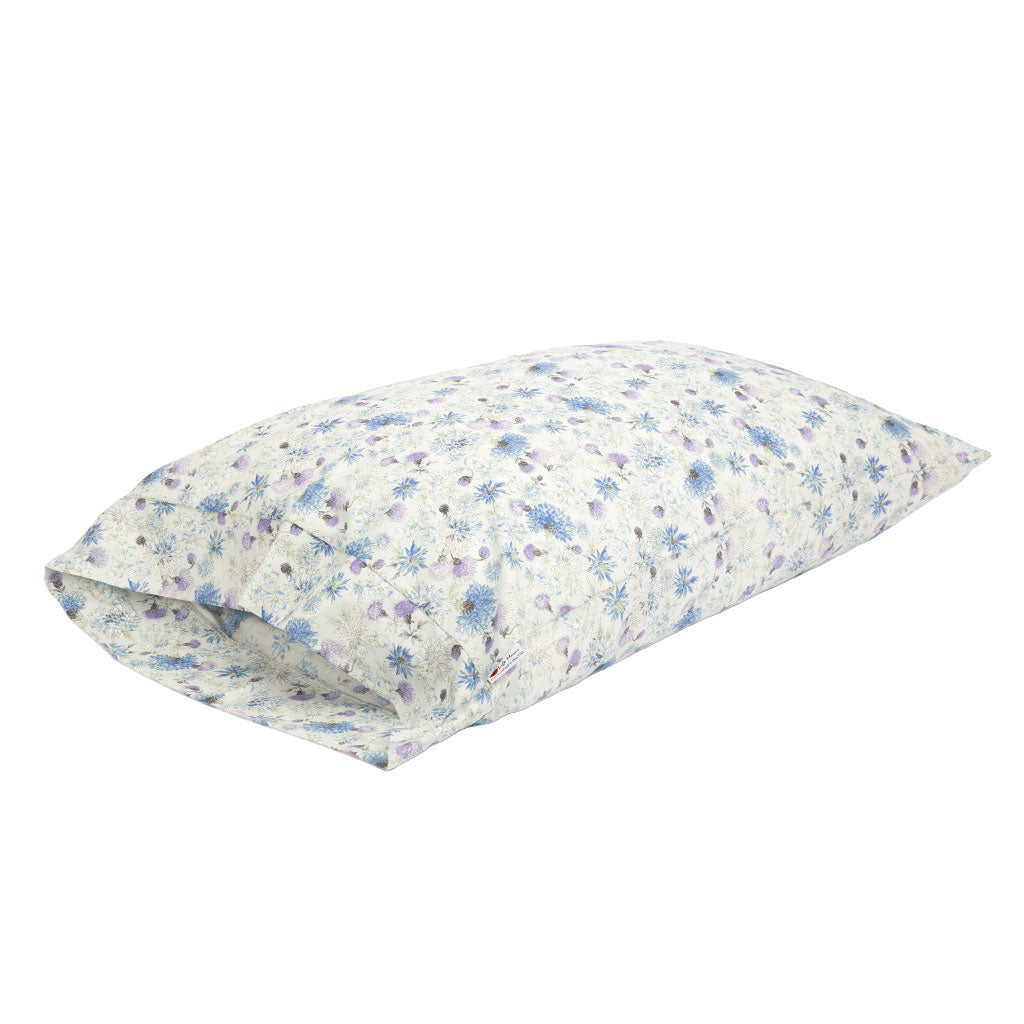 A rectangular pillowcase featuring a delicate blue and purple floral pattern on a white background, shown on a plain white studio background.