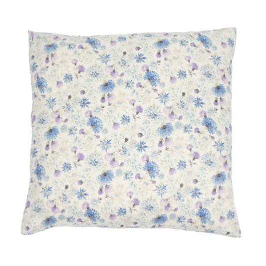 A square decorative throw pillow featuring a delicate floral print with blue and purple flowers on a warm cream background, shown against a plain white studio backdrop.