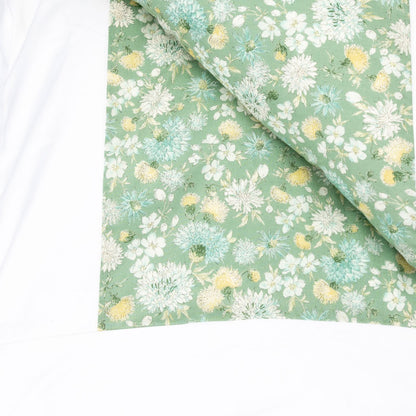 A folded piece of sage green fabric with a dense floral print of white, light blue, and yellow flowers, displayed on a clean white background.