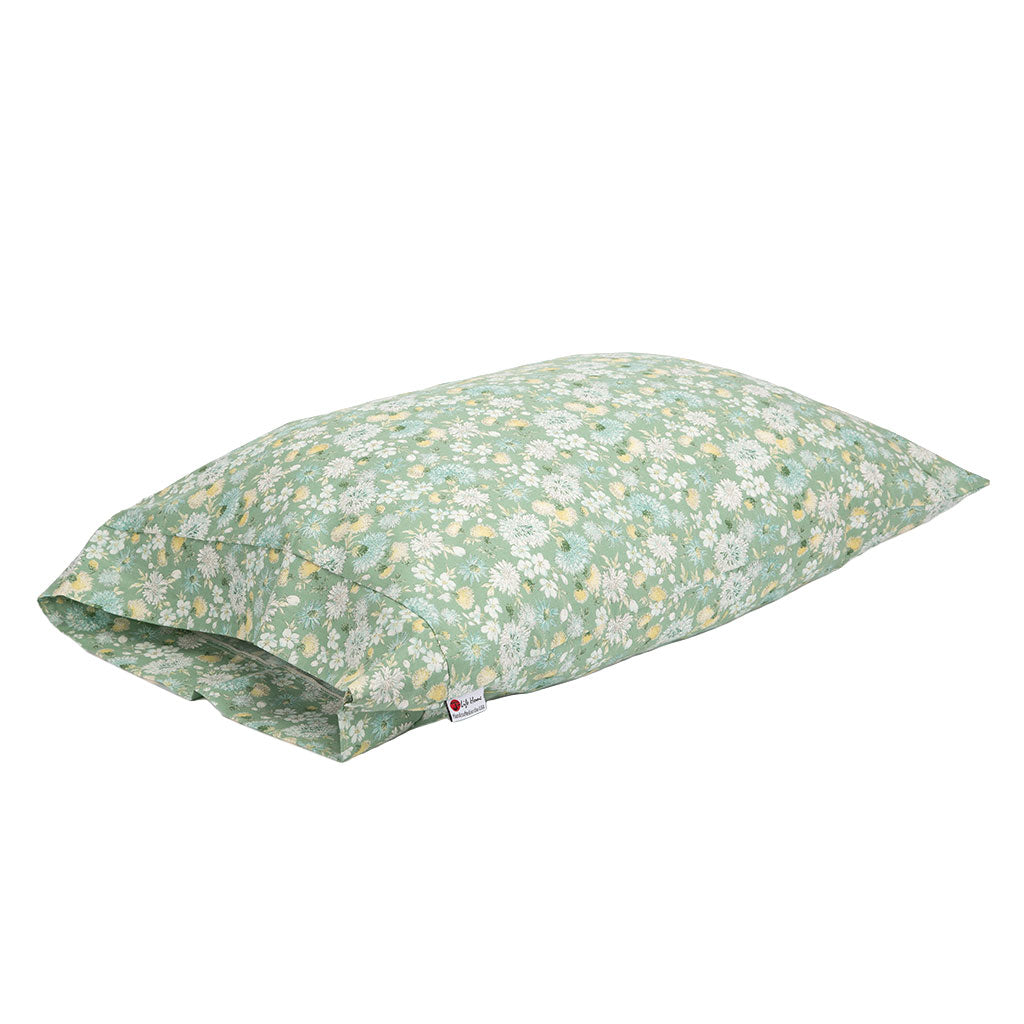 A rectangular pillowcase featuring a light sage green background with a dense white and pale yellow floral print, shown on a plain white background.