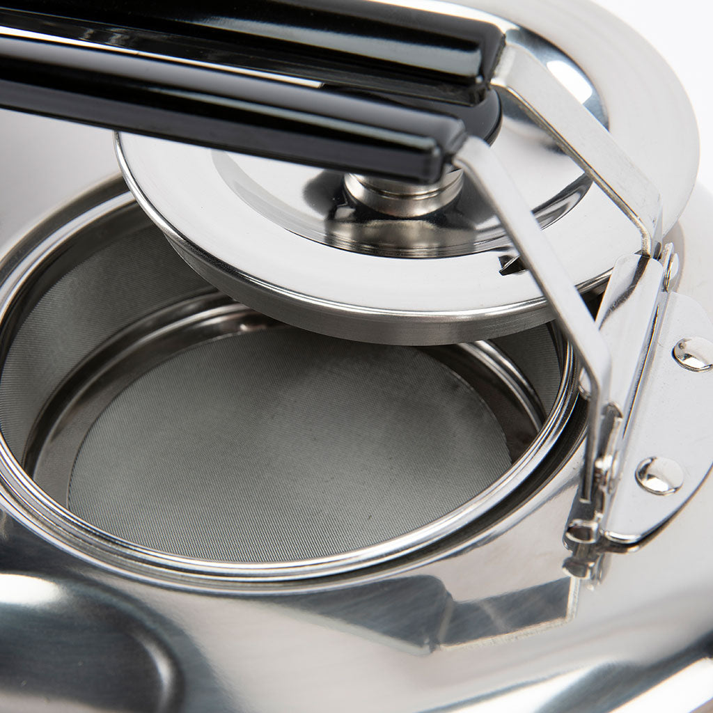 Close-up of a silver teapot with open lid