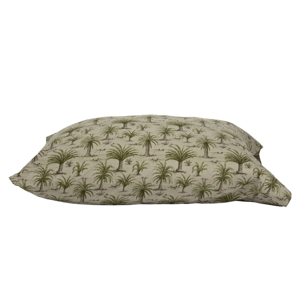 A rectangular pillowcase with a repeating palm tree pattern in olive green on a light beige background, shown against a plain white studio backdrop.
