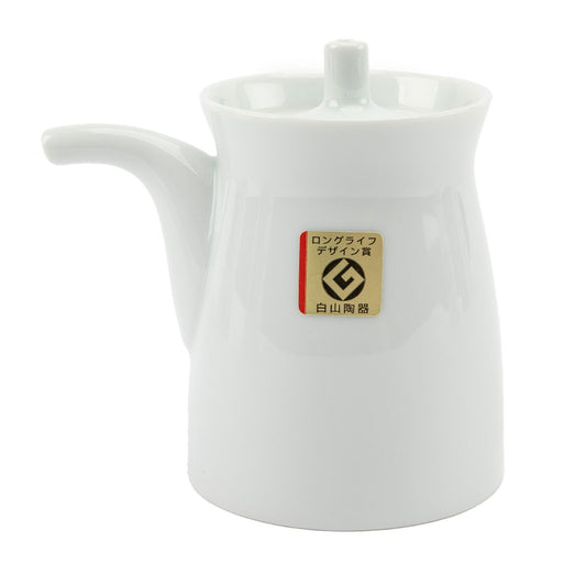 White ceramic soy sauce dispenser with a brand label on a white background