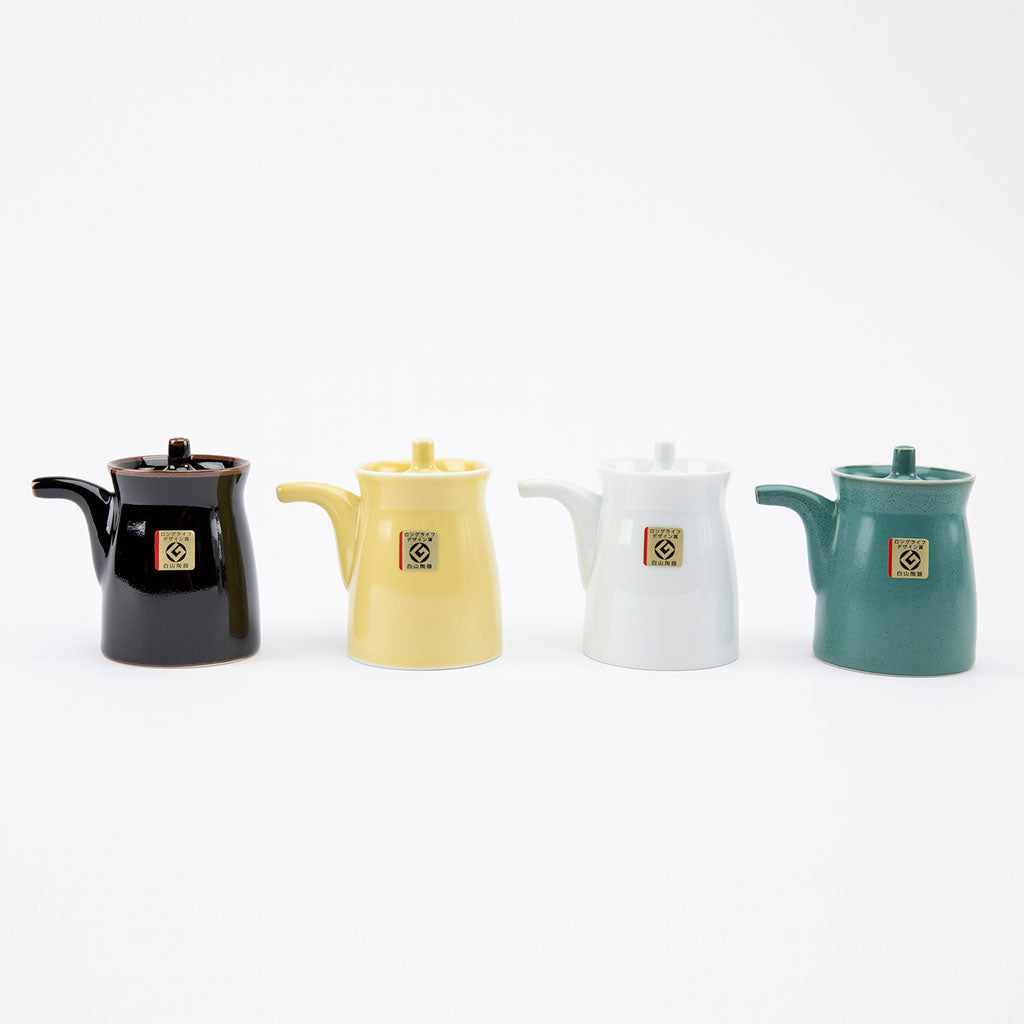 Four soy sauce dispensers on a white background