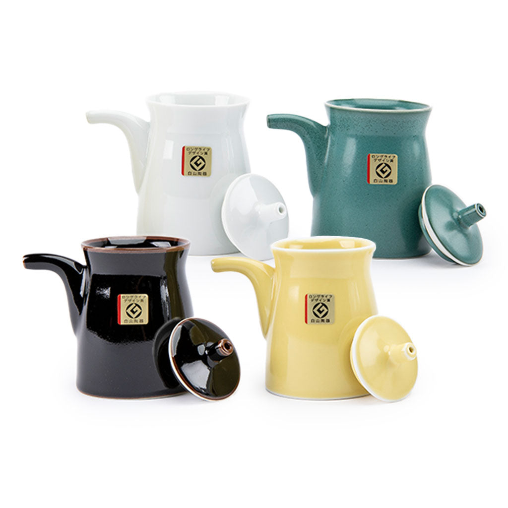 Four soy sauce dispensers on a white background