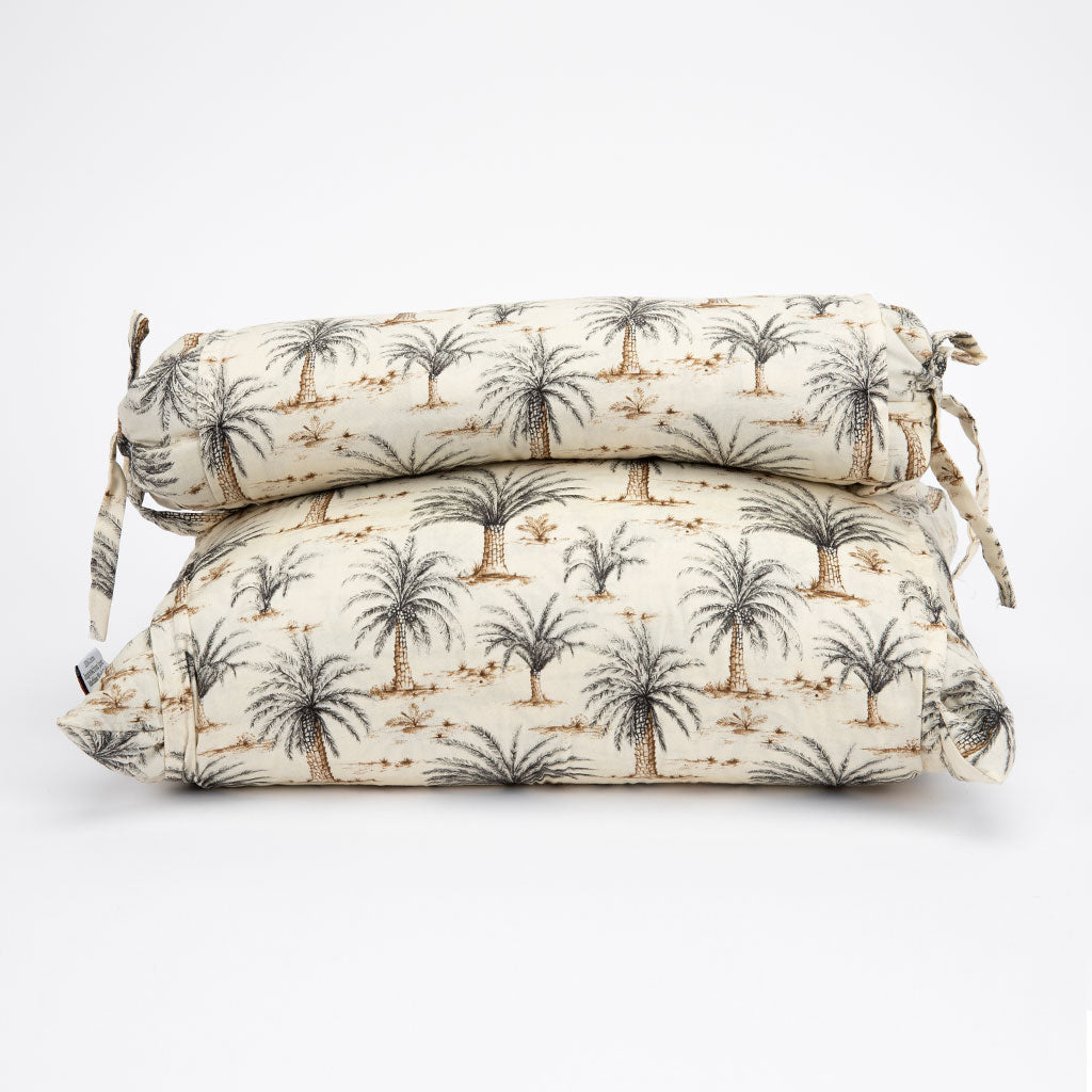 Two rectangular buckwheat hull pillows with a palm tree print, stacked on a plain white background.
