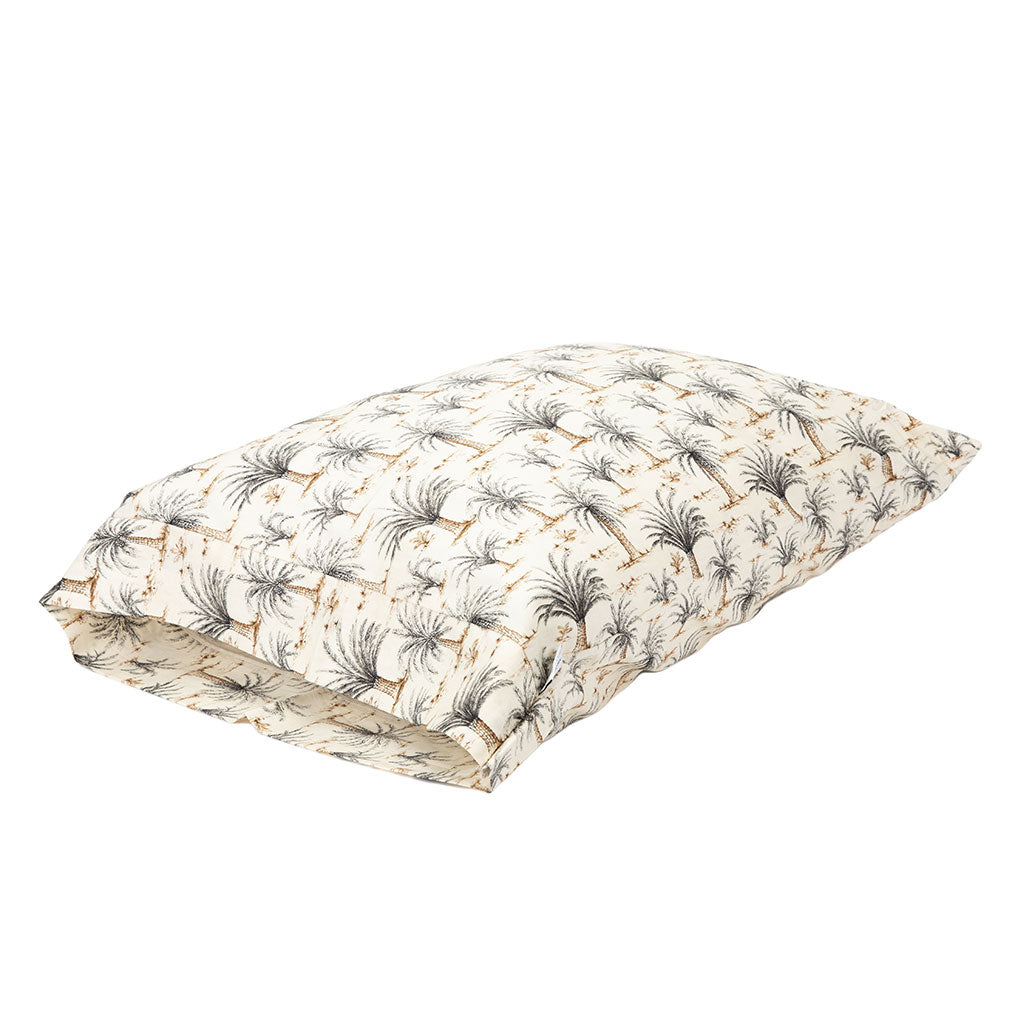 A rectangular quilted pillow or cushion with a repeating palm tree pattern on a warm cream background, shown on a plain white studio background.
