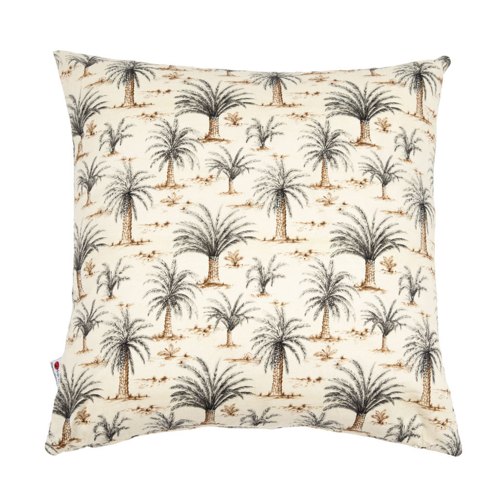 A square throw pillow featuring an all-over palm tree pattern on a warm cream background, photographed against a seamless white studio background.