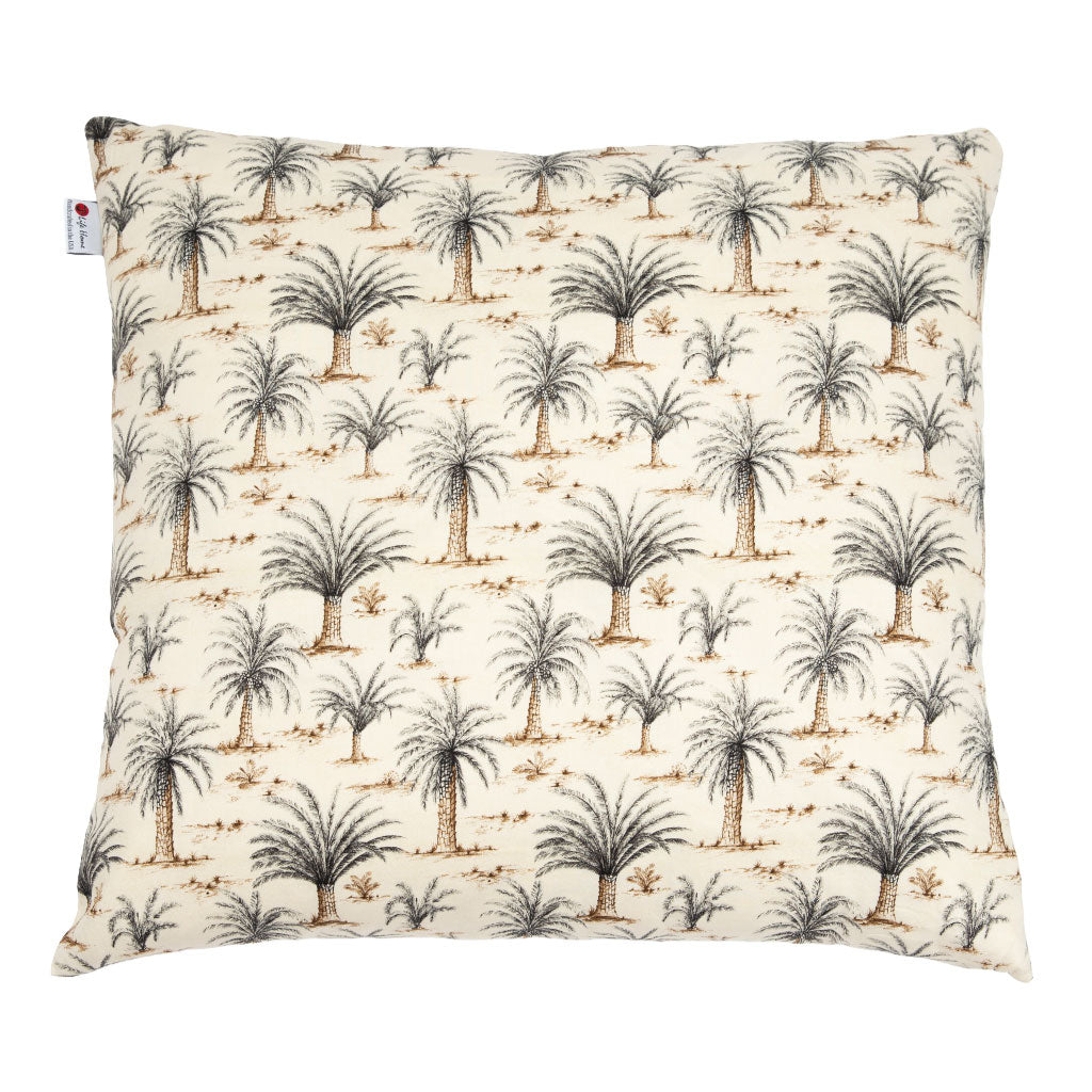 A square decorative throw pillow featuring a repeating palm tree pattern on a warm cream background, with a small white brand tag on the left edge.