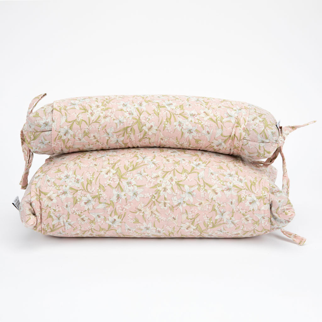 Two buckwheat hull pillows stacked on a white background, featuring a delicate pink and sage green floral pattern.