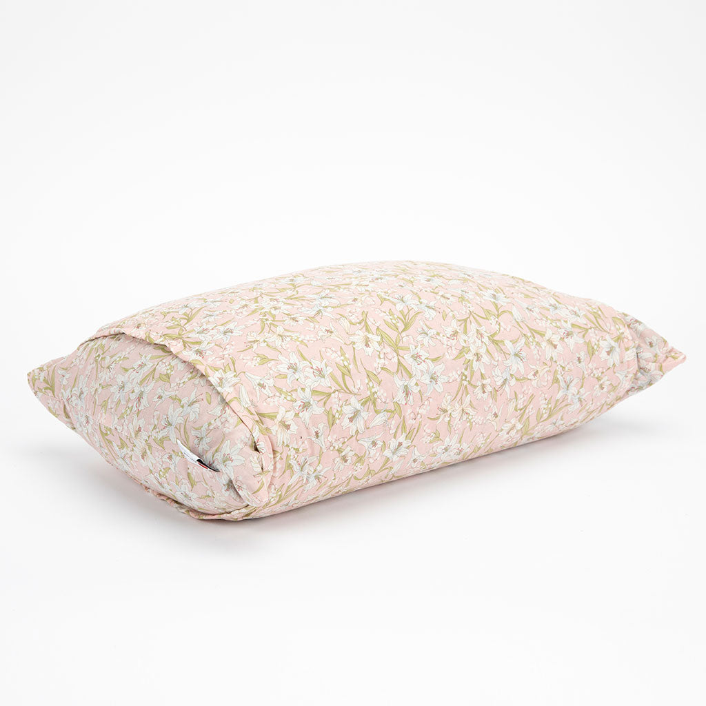 A rectangular buckwheat hull pillow with a light pink and beige floral pattern, shown on a clean white background.