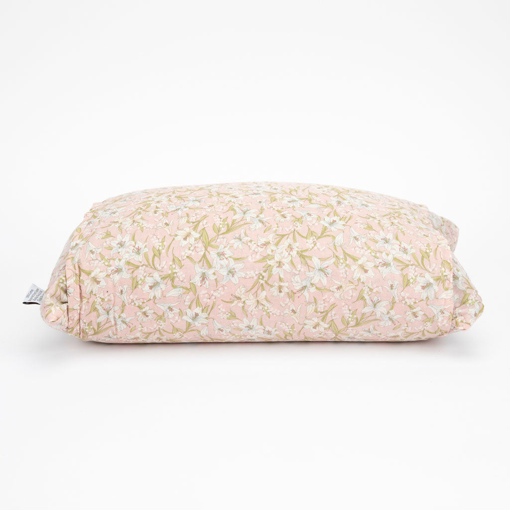 A rectangular buckwheat pillow with a light pink and beige floral pattern, shown on a clean white background.