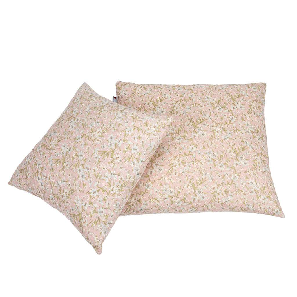 Two decorative throw pillows with a delicate floral print in soft pink, beige, and white, displayed against a solid white background.