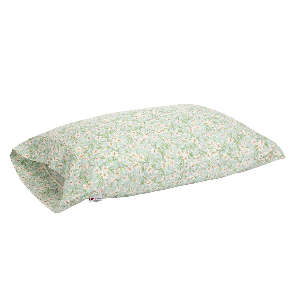 A rectangular pillowcase with a light sage green background and a delicate white and pink floral print with green stems, shown on a plain white background.