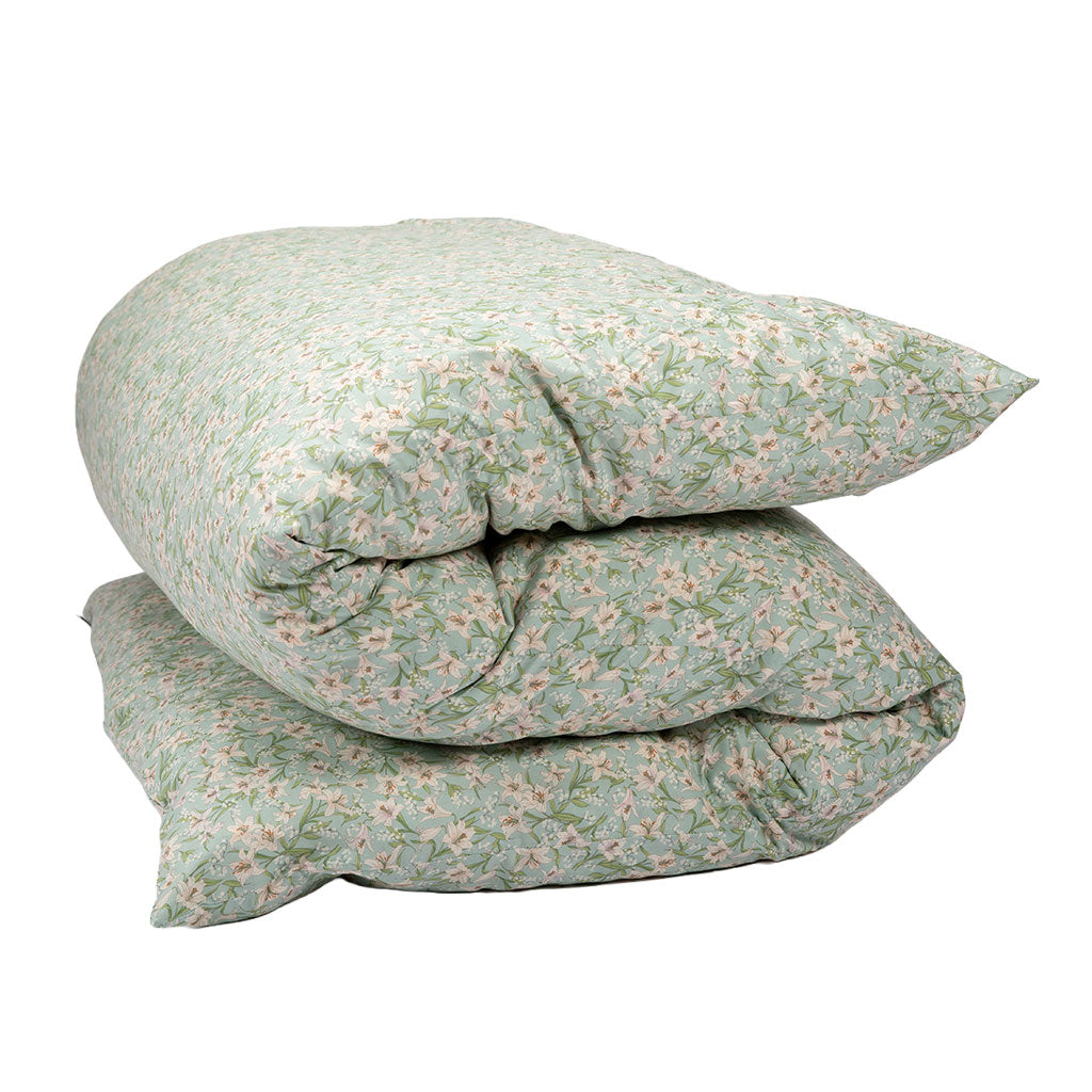 A shikifuton mattress with a light sage green and white floral pattern, isolated on a white background.